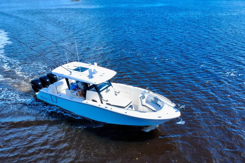 Slide: The Image of 2022 Robalo R360 Center Console boat cruising on open water. - 10