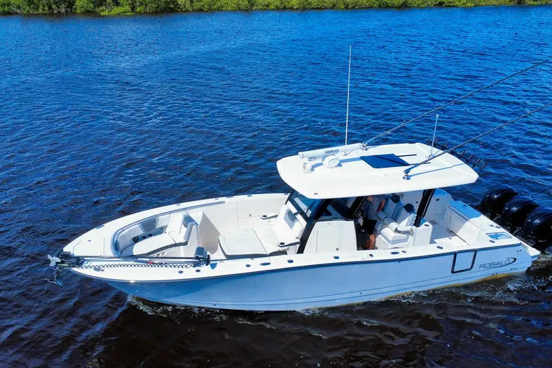 Slide: The Image of 2022 Robalo R360 Center Console boat cruising on blue water. - 12
