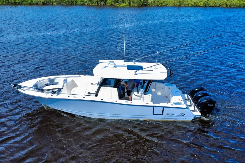 Slide: The Image of 2022 Robalo R360 Center Console boat cruising on blue water. - 13