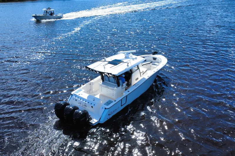Slide: The Image of 2022 Robalo R360 Center Console boat cruising on a sunny day. - 16
