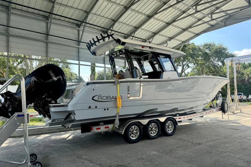 Slide: The Image of 2022 Robalo R360 Center Console boat on trailer under shelter. - 18