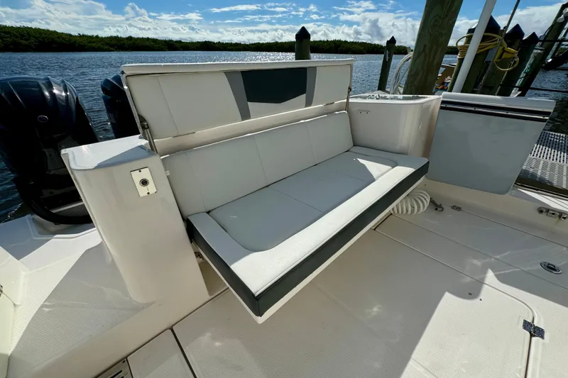 Slide: The Image of 2022 Robalo R360 Center Console boat with foldable seating and scenic water backdrop. - 26