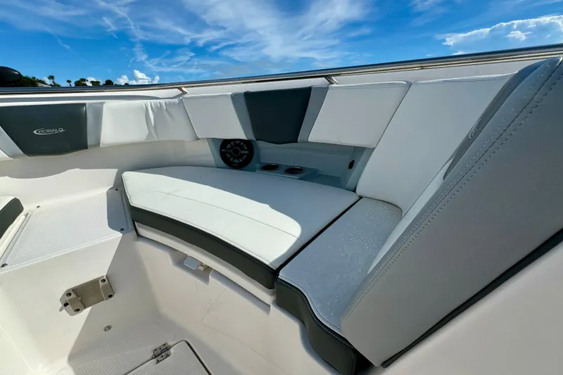 Slide: The Image of 2022 Robalo R360 Center Console boat interior with cushioned seating and speaker. - 29