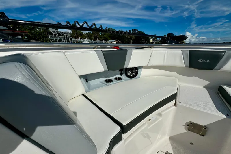 Slide: The Image of 2022 Robalo R360 Center Console boat interior with white seating and speaker. - 30
