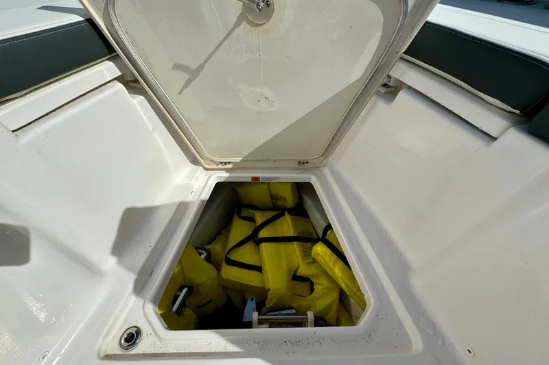 Slide: The Image of Storage compartment on 2022 Robalo R360 Center Console with yellow life jackets. - 31