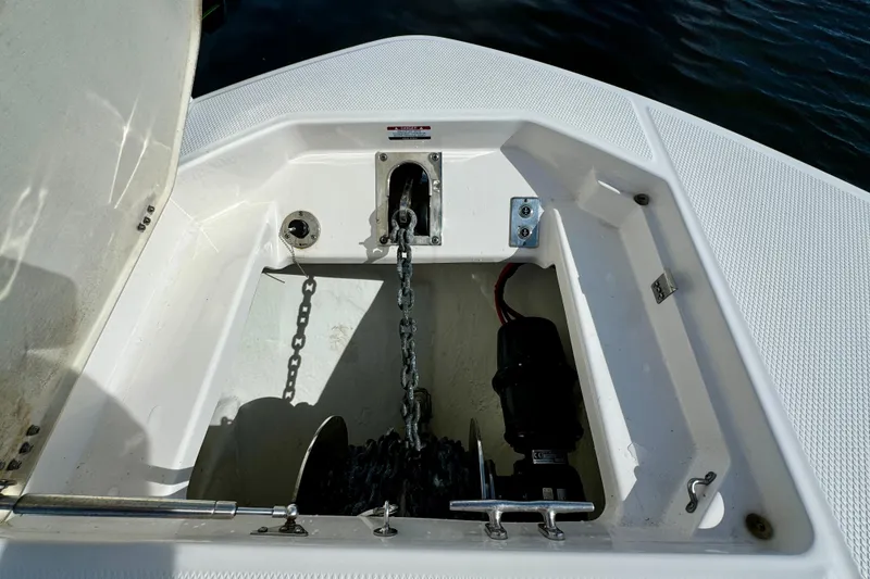 Slide: The Image of 2022 Robalo R360 Center Console anchor compartment with chain and winch system. - 32