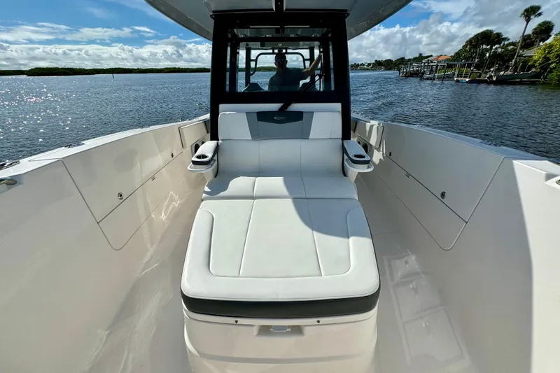 Slide: The Image of 2022 Robalo R360 Center Console boat interior with seating, on a sunny day. - 34