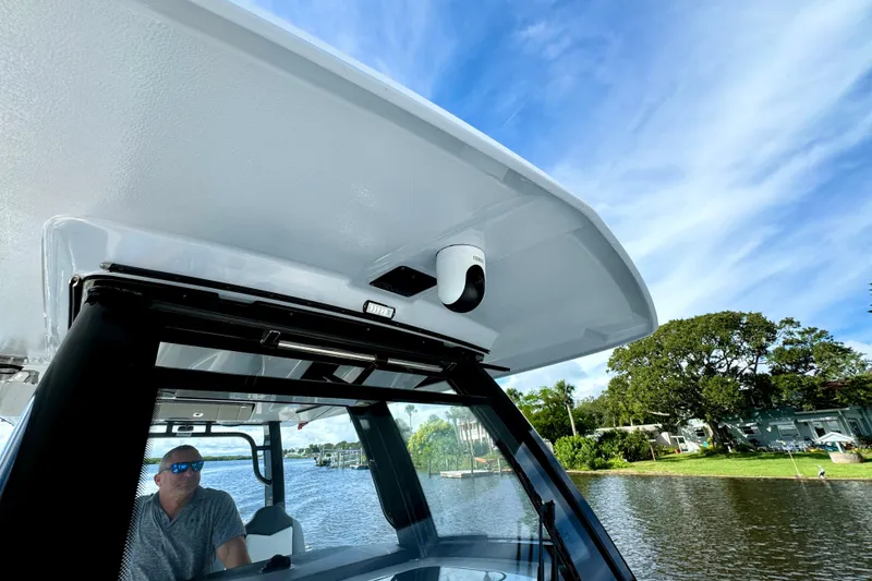 Slide: The Image of 2022 Robalo R360 Center Console boat on water, featuring sleek design and modern technology. - 35