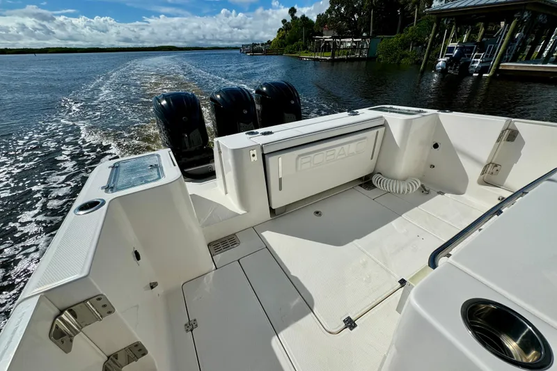 Slide: The Image of 2022 Robalo R360 Center Console boat cruising on a scenic waterway. - 36
