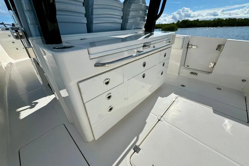 Slide: The Image of 2022 Robalo R360 Center Console boat interior with storage drawers and seating. - 41