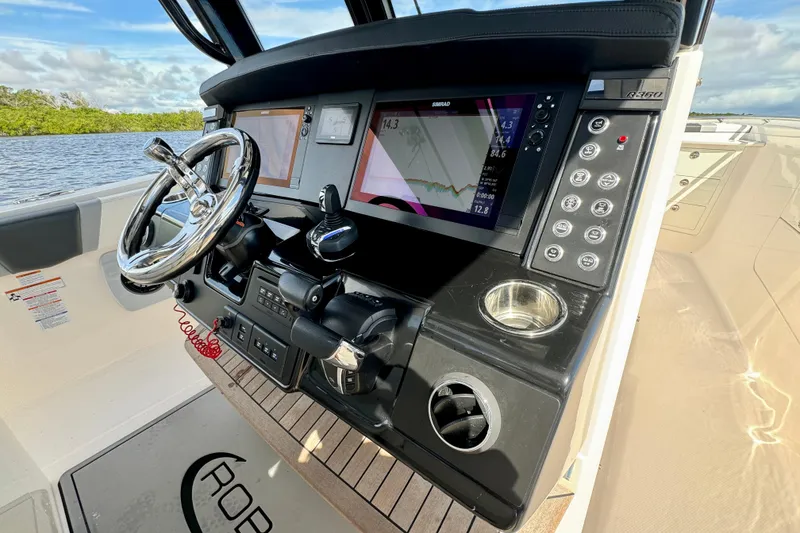 Slide: The Image of 2022 Robalo R360 Center Console dashboard with advanced navigation controls and displays. - 47