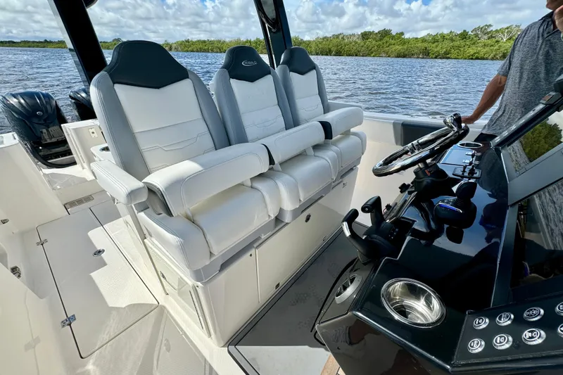 Slide: The Image of 2022 Robalo R360 Center Console boat interior with luxurious seating and modern controls. - 52