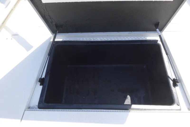 Slide: The Image of Open storage compartment in 2024 Ranger RB200 boat. - 11