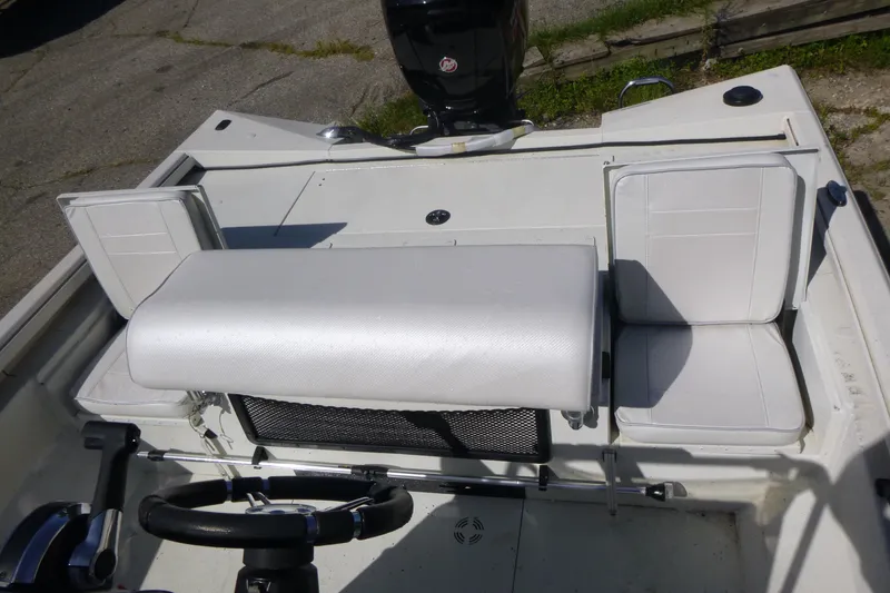 Slide: The Image of 2024 Ranger RB200 boat interior with white seating and steering wheel. - 13