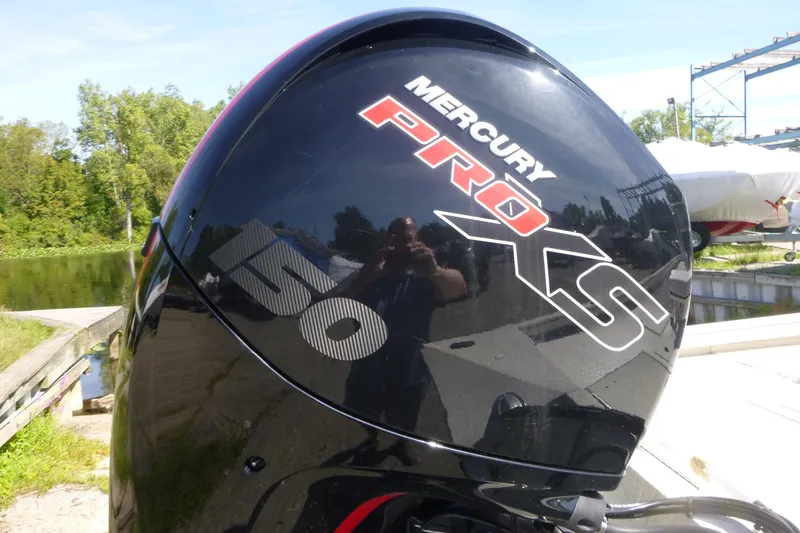 Slide: The Image of Mercury Pro XS 150 outboard motor on 2024 Ranger RB200 boat by a lakeside. - 15