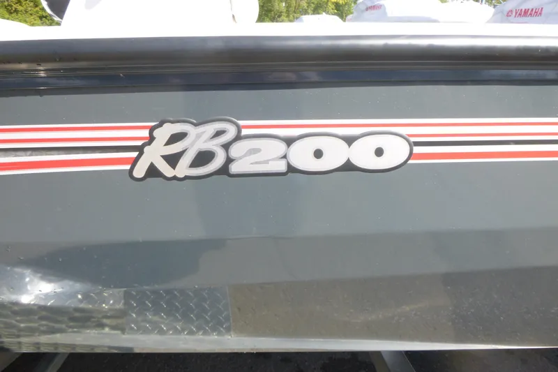 Slide: The Image of 2024 Ranger RB200 boat with red and white stripes on the side. - 16