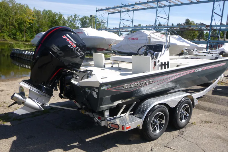 Slide: The Image of 2024 Ranger RB200 boat with Mercury engine on trailer by the water. - 2