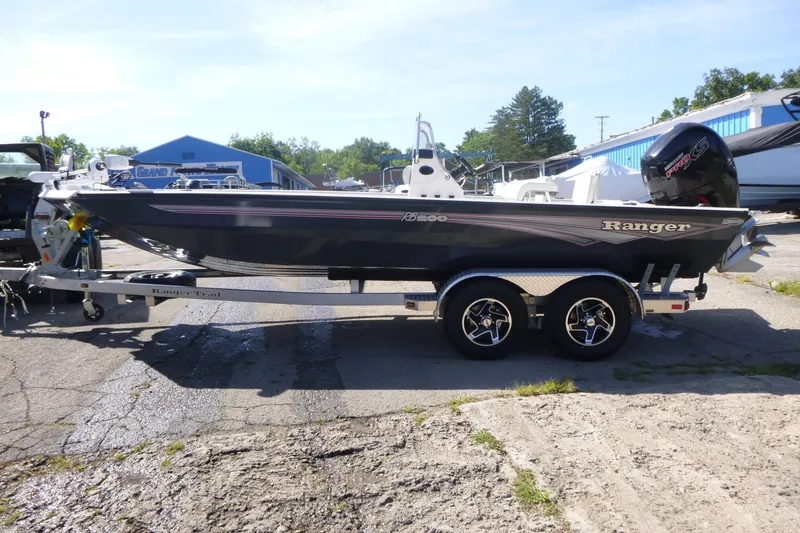 Slide: The Image of 2024 Ranger RB200 boat on trailer, parked outdoors, featuring sleek design and modern features. - 4