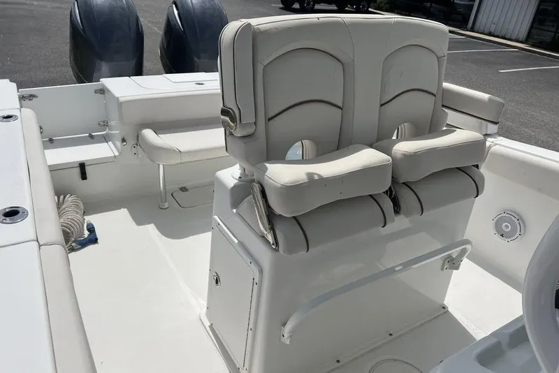 Slide: The Image of 2021 Sea Hunt Gamefish 25 boat interior with dual seats and twin engines. - 12