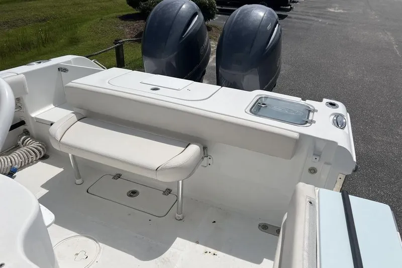 Slide: The Image of 2021 Sea Hunt Gamefish 25 boat interior with seating and dual outboard motors. - 14