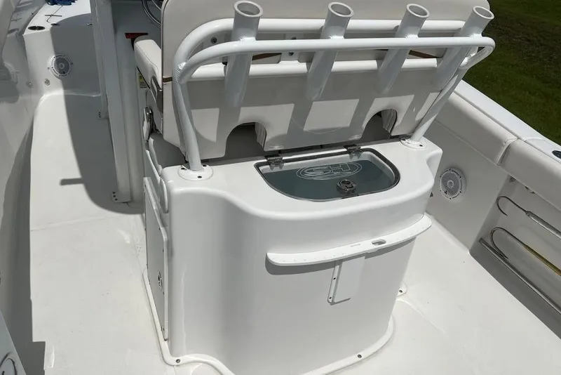 Slide: The Image of 2021 Sea Hunt Gamefish 25 boat interior with rod holders and storage compartment. - 18