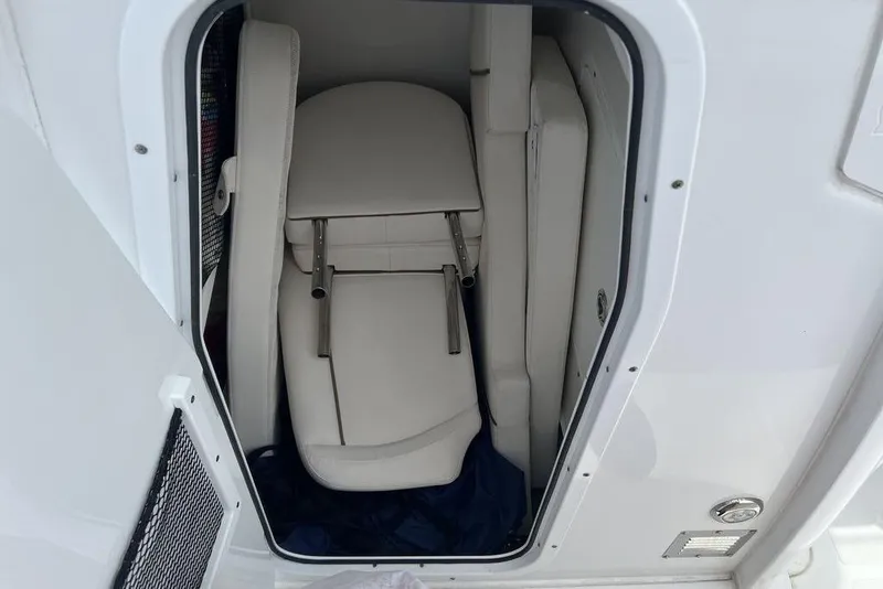 Slide: The Image of 2021 Sea Hunt Gamefish 25 storage compartment with folded white seats. - 19