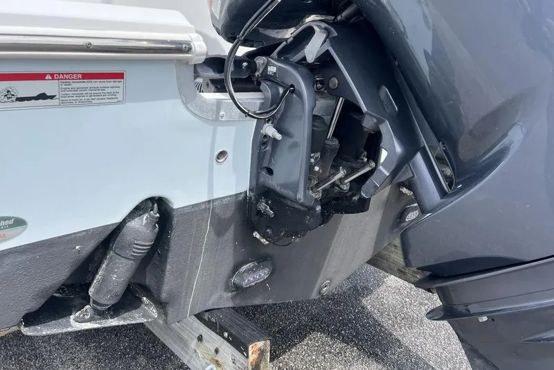 Slide: The Image of 2021 Sea Hunt Gamefish 25 boat engine close-up, showing motor and mounting details. - 20