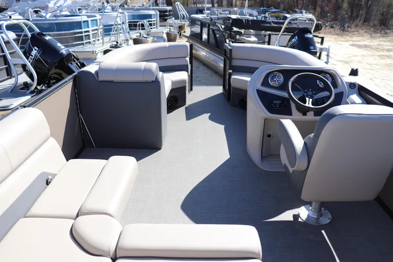 Slide: The Image of 2025 Flagship Freedom 18 pontoon boat interior with plush seating and modern steering console. - 6
