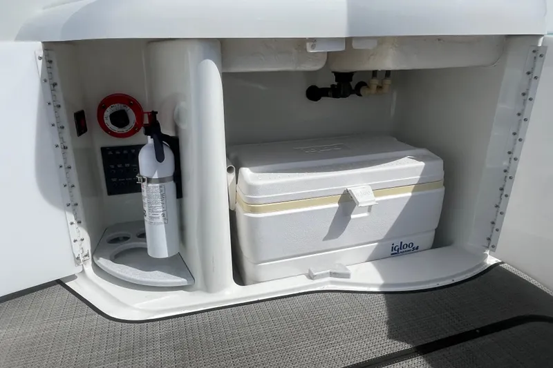 Slide: The Image of Storage compartment of a 1996 Formula 330 Sun Sport with cooler and fire extinguisher. - 11