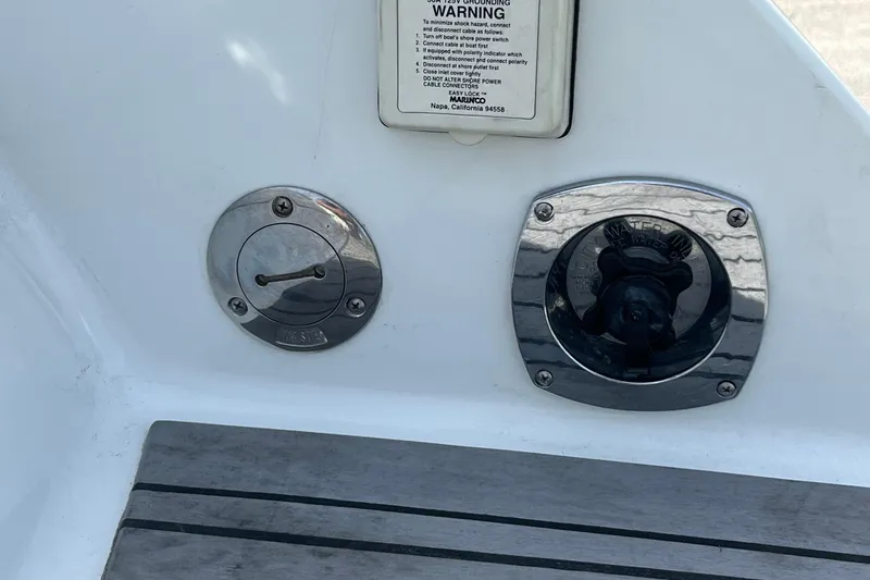 Slide: The Image of 1996 Formula 330 Sun Sport boat fittings and warning label on deck. - 12