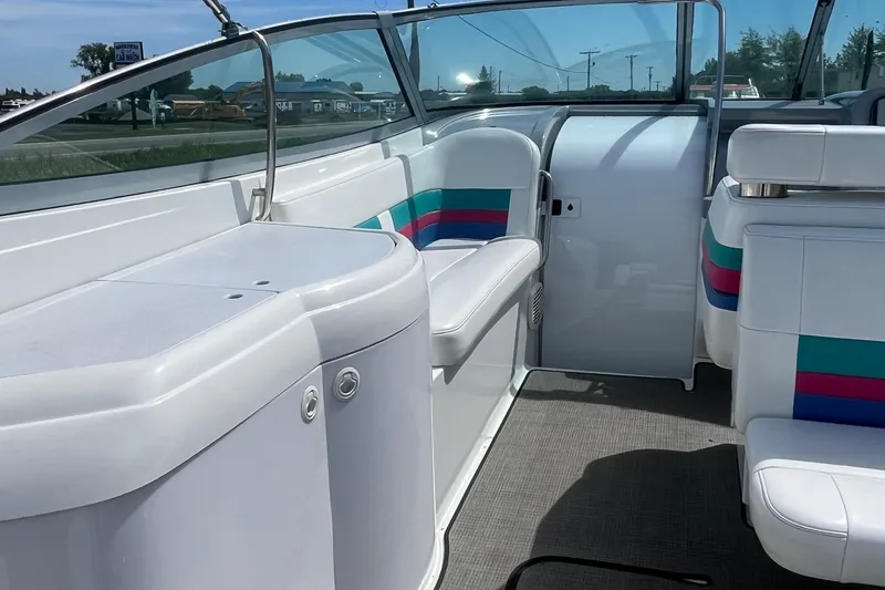 Slide: The Image of 1996 Formula 330 Sun Sport boat interior with white seating and colorful accents. - 13