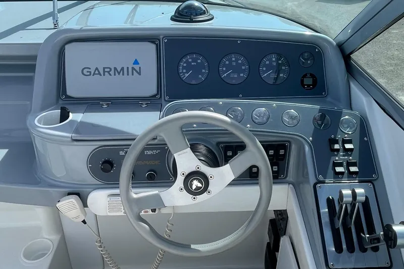 Slide: The Image of 1996 Formula 330 Sun Sport boat dashboard with Garmin navigation system and control panel. - 15