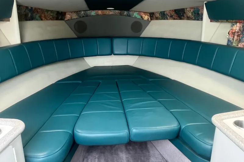 Slide: The Image of Interior of a 1996 Formula 330 Sun Sport boat with teal seating and floral accents. - 18