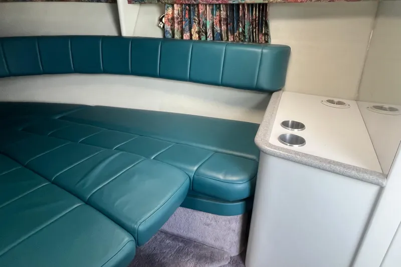 Slide: The Image of Interior of a 1996 Formula 330 Sun Sport boat with teal seating and cup holders. - 19