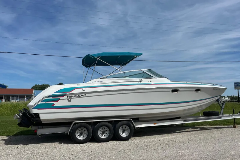 Slide: The Image of 1996 Formula 330 Sun Sport boat on trailer, featuring sleek design and vibrant accents. - 2