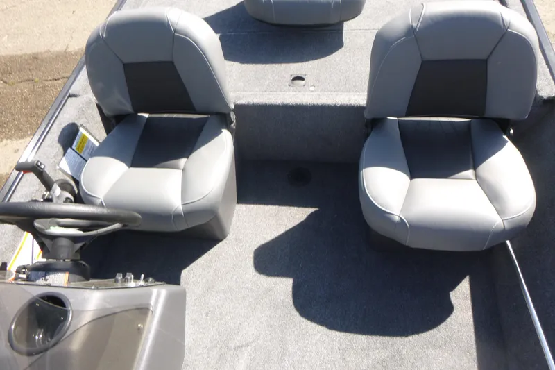 Slide: The Image of 2026 Tracker Bass Tracker Classic XL boat interior with two gray seats and steering console. - 10