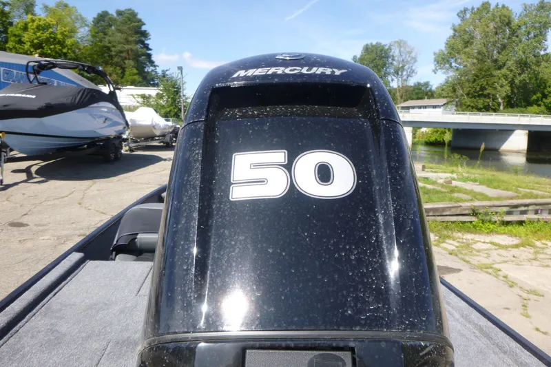 Slide: The Image of 2026 Tracker Bass Tracker Classic XL with Mercury 50 horsepower engine by a river. - 14