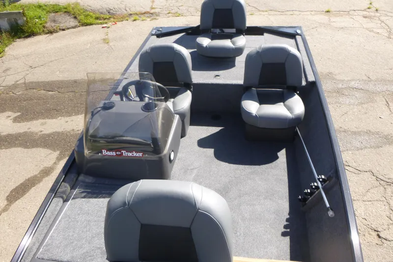 Slide: The Image of 2026 Tracker Bass Tracker Classic XL boat interior with gray seating and steering console. - 6