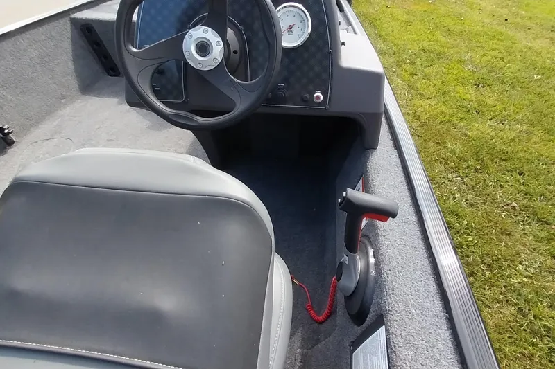 Slide: The Image of 2023 Tracker Bass Tracker Classic XL boat interior with steering wheel and throttle control. - 10