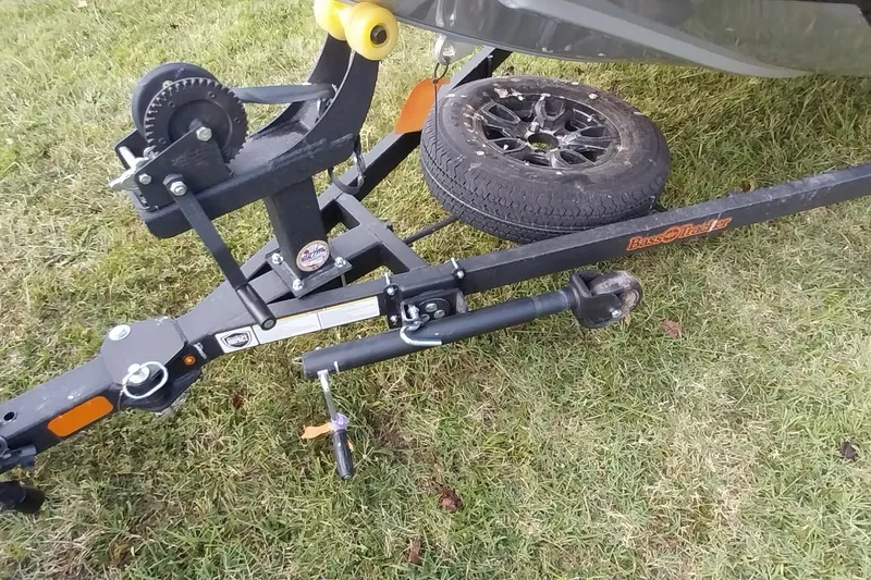 Slide: The Image of 2023 Tracker Bass Tracker Classic XL trailer hitch and spare tire on grass. - 2
