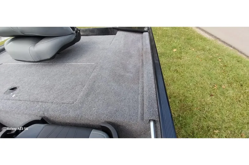 Slide: The Image of 2023 Tracker Bass Tracker Classic XL boat interior with gray carpet and seating. - 20