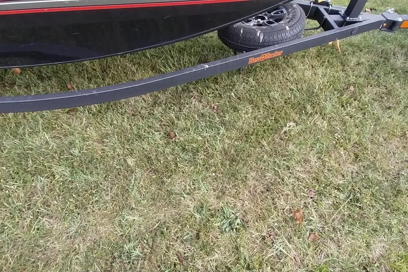 Slide: The Image of 2023 Tracker Bass Tracker Classic XL trailer on grass, showcasing tire and frame details. - 25