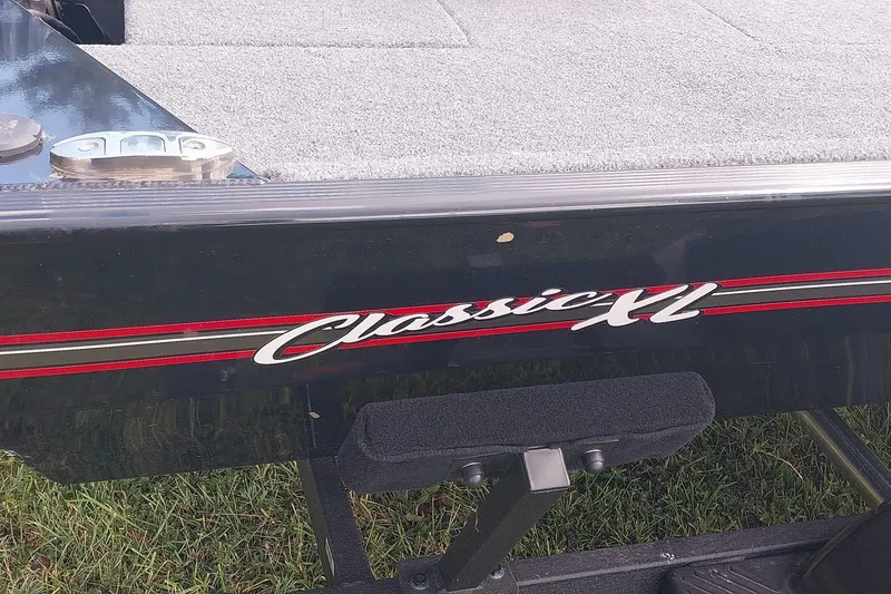 Slide: The Image of 2023 Tracker Bass Tracker Classic XL boat detail with logo and deck view. - 7