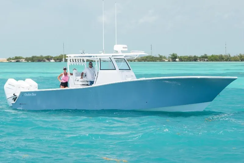 Slide: The Image of 2024 Onslow Bay 37 Offshore boat cruising in clear turquoise waters. - 1