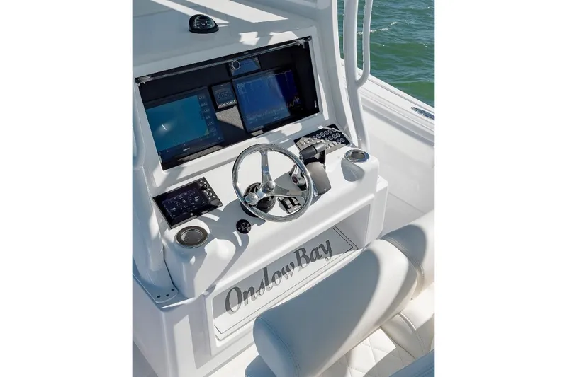 Slide: The Image of 2024 Onslow Bay 37 Offshore boat console with advanced navigation displays and controls. - 10