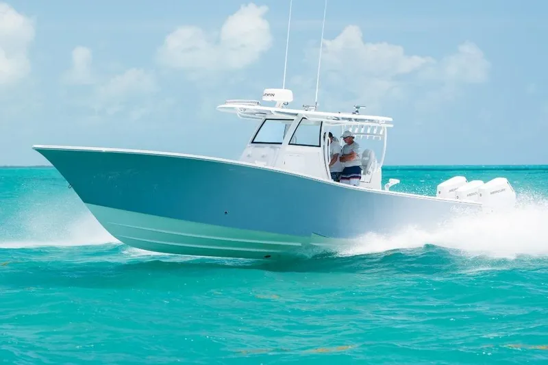 Slide: The Image of 2024 Onslow Bay 37 Offshore boat cruising on turquoise water under clear skies. - 2