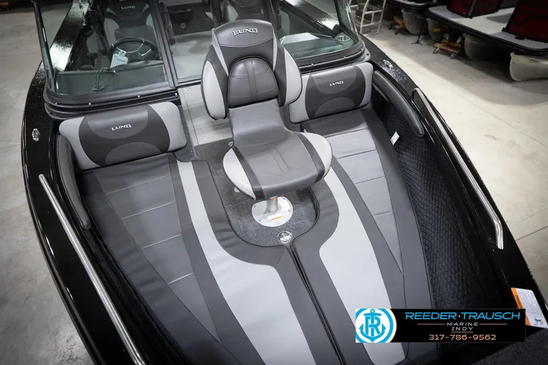 Slide: The Image of 2026 Lund 2275 Baron boat interior with gray seating and steering wheel. - 13