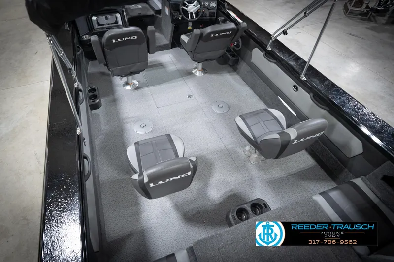 Slide: The Image of 2026 Lund 2275 Baron boat interior with four seats and steering console. - 15