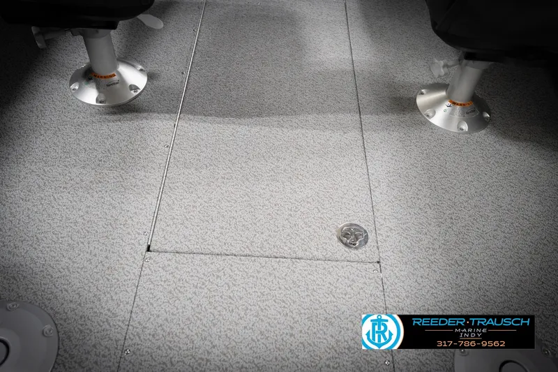 Slide: The Image of Interior flooring of 2026 Lund 2275 Baron boat with pedestal seats and textured surface. - 25