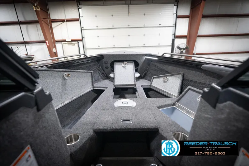Slide: The Image of 2026 Lund 2275 Baron boat interior with storage compartments in a showroom. - 34